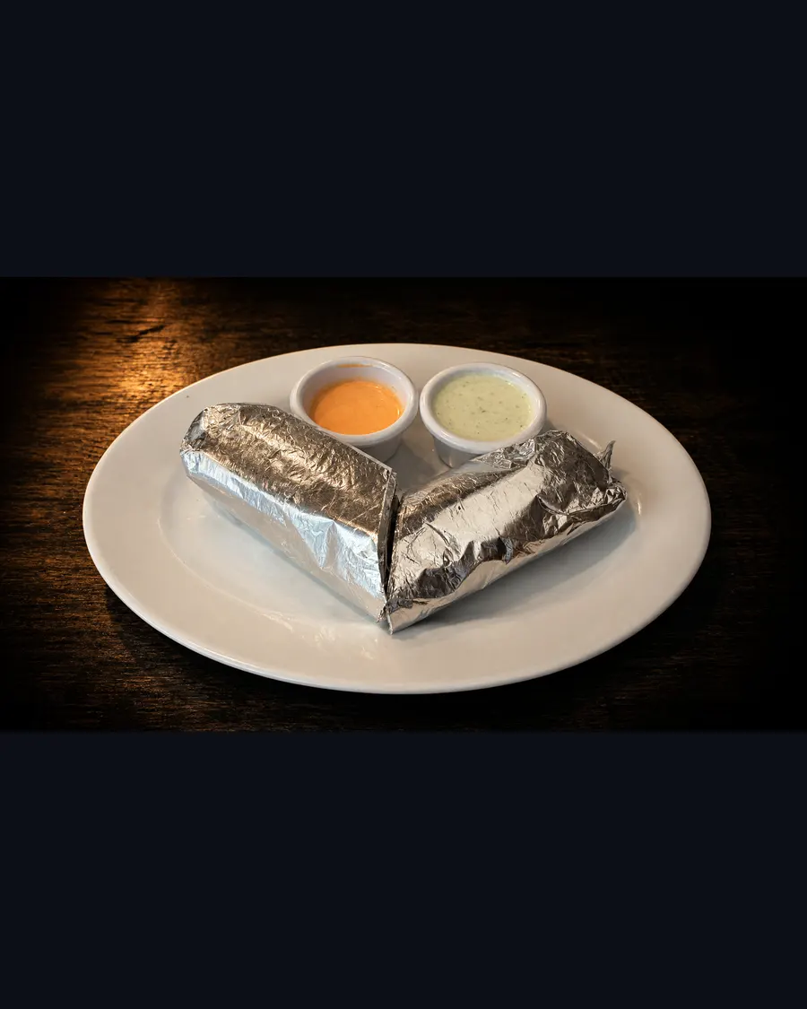 Two wrapped dürüm sandwiches with sauces